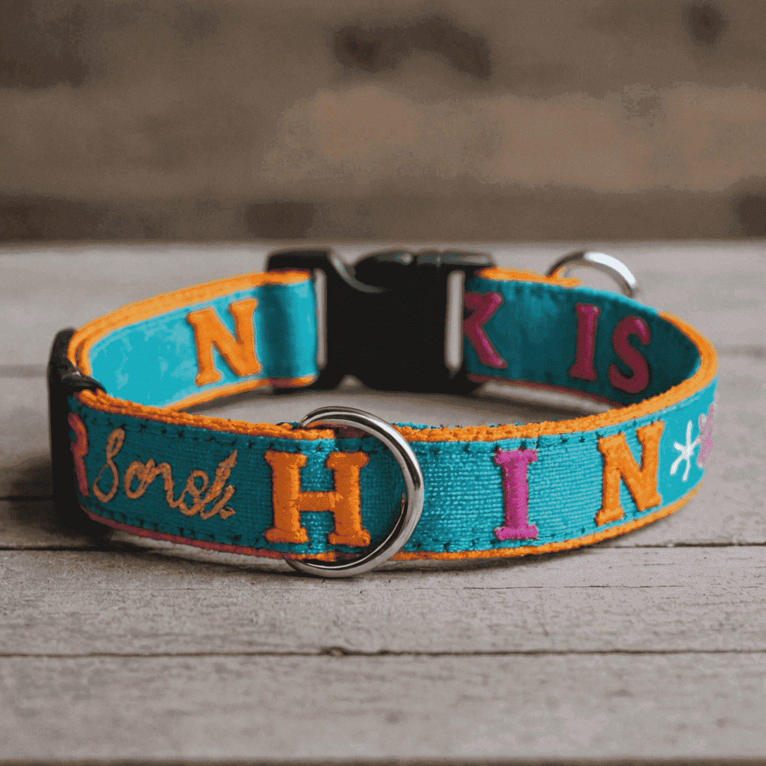 A colorful DIY pet collar made with fabric and embroidered with a pet's name